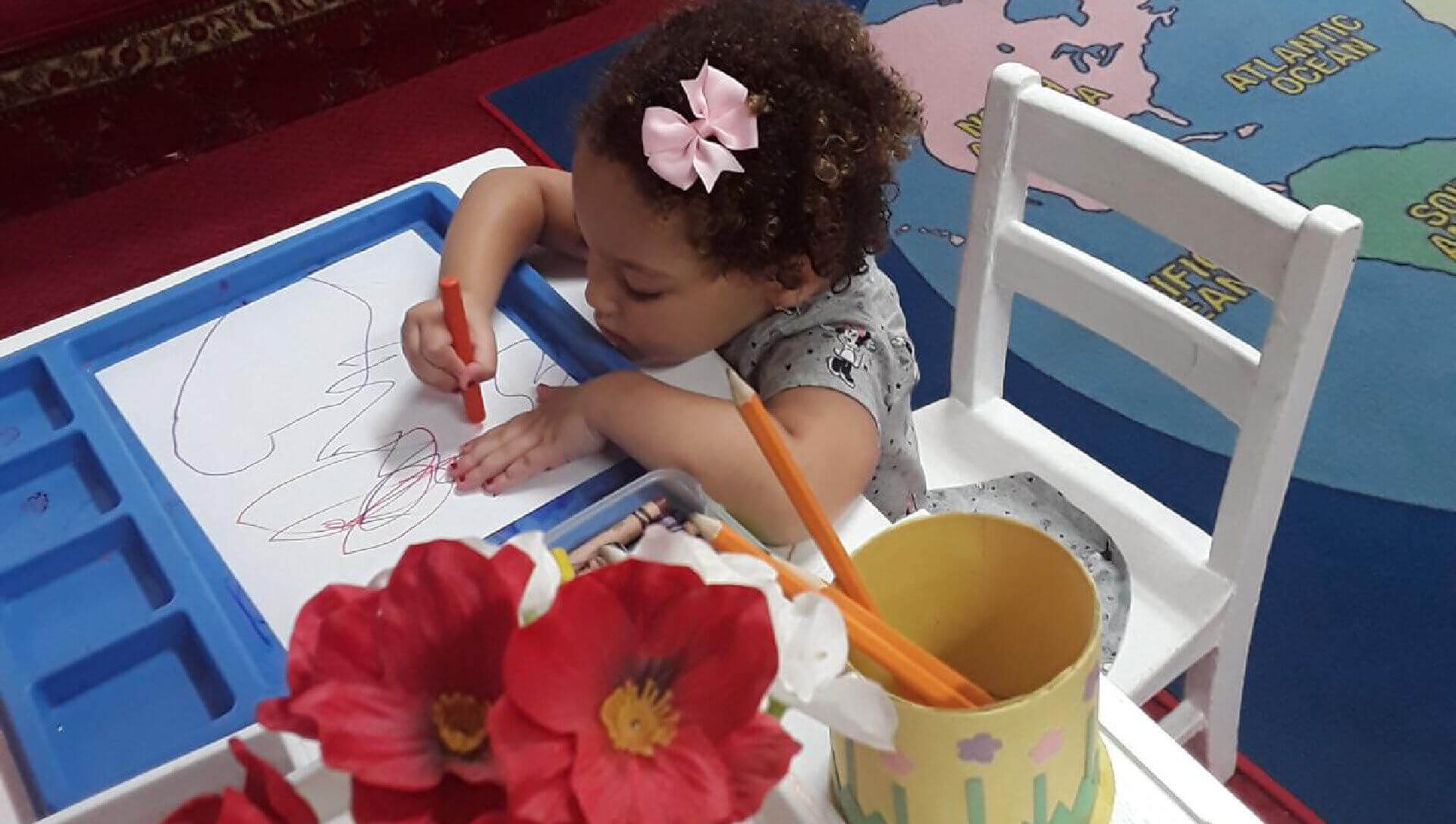 A young boy focused on painting a colorful masterpiece